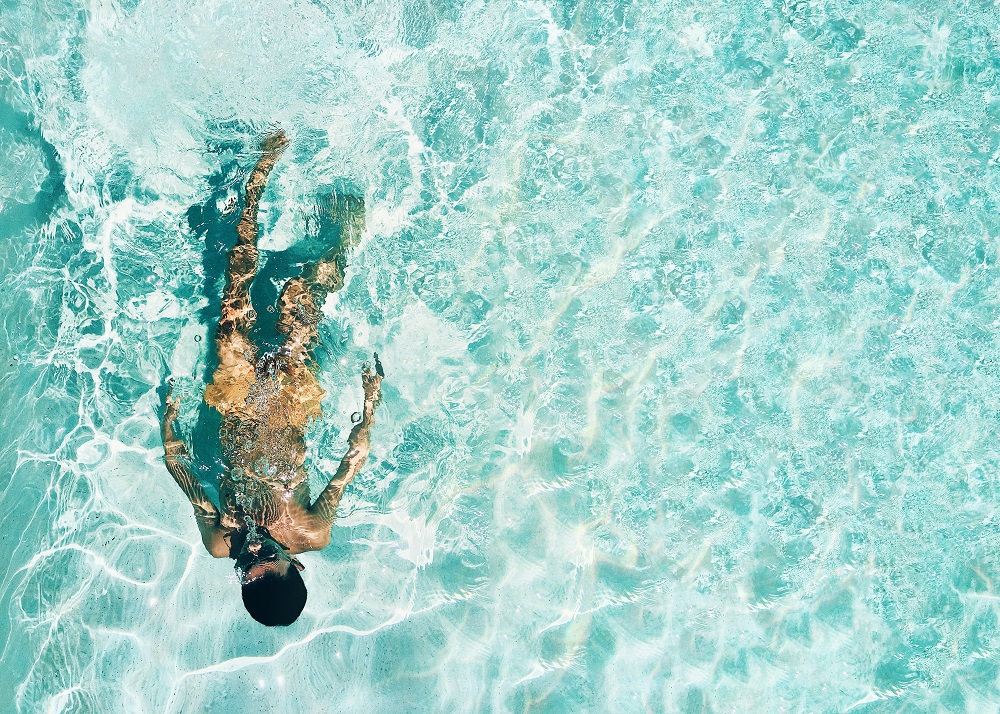 Man Floating in Clear Ocean