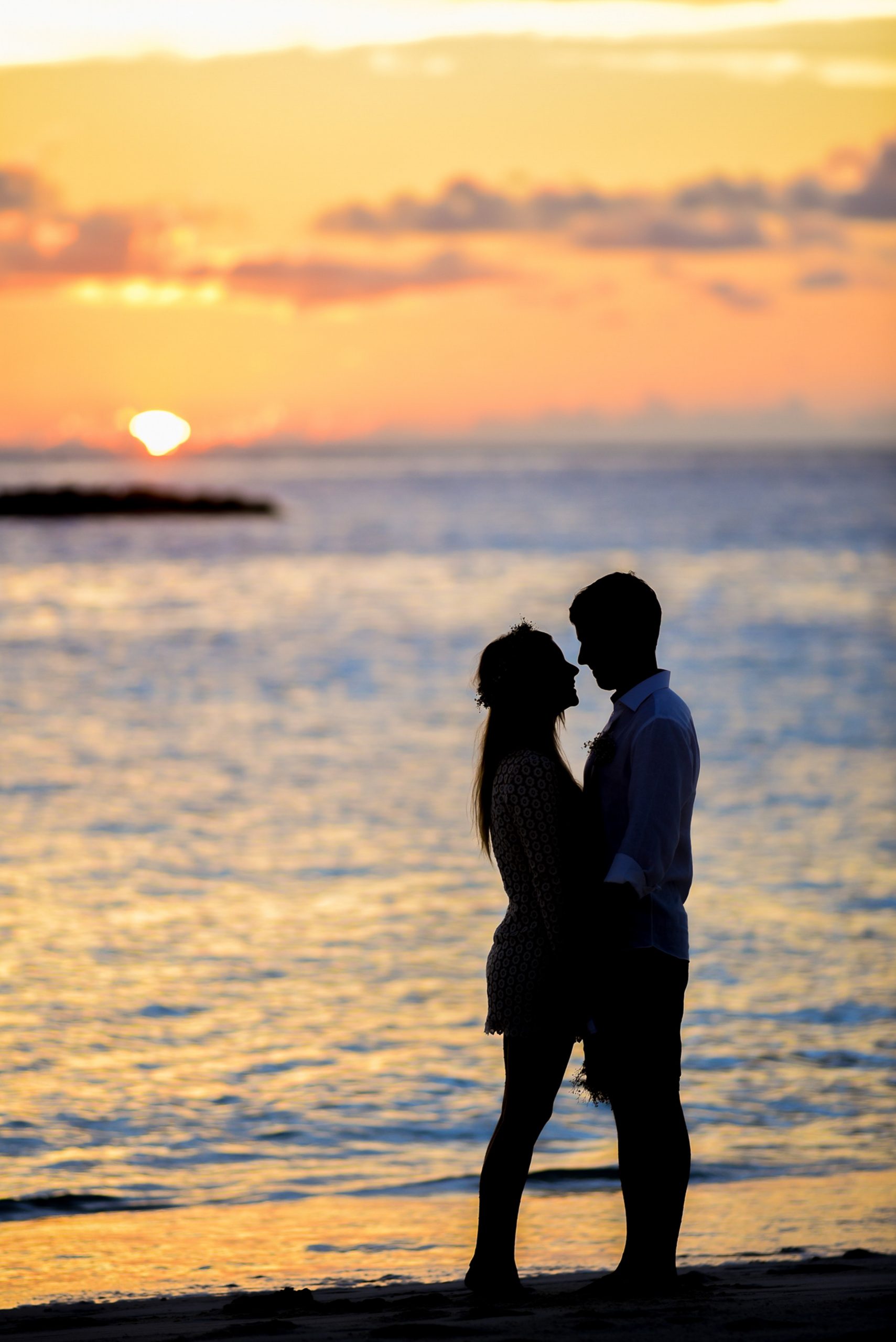 Couple on beach at sunset